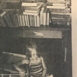 Rory Obrate guards a box of mom's books while reading a picture book - The Sunday Star-Bulletin & Advertiser