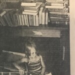Rory Obrate guards a box of mom's books while reading a picture book - The Sunday Star-Bulletin & Advertiser