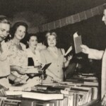 Auctioneer, James Madden, accepts bids. From left to right: Dr. Pauline Stitt, Mrs. F.H. Tillotson, Mrs. Albert K Lyman, and Mrs. H.W. Boynton